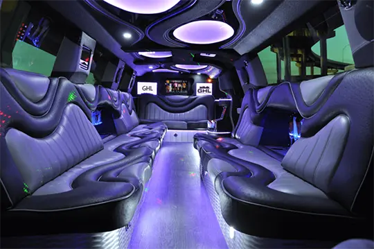 Interior of a party bus limo in Dallas showing bar area, comfortable seats — great for group events and celebrations.