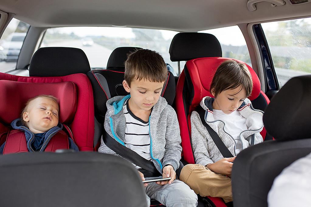 Child safely seated in a car seat inside a clean Houston town car service vehicle