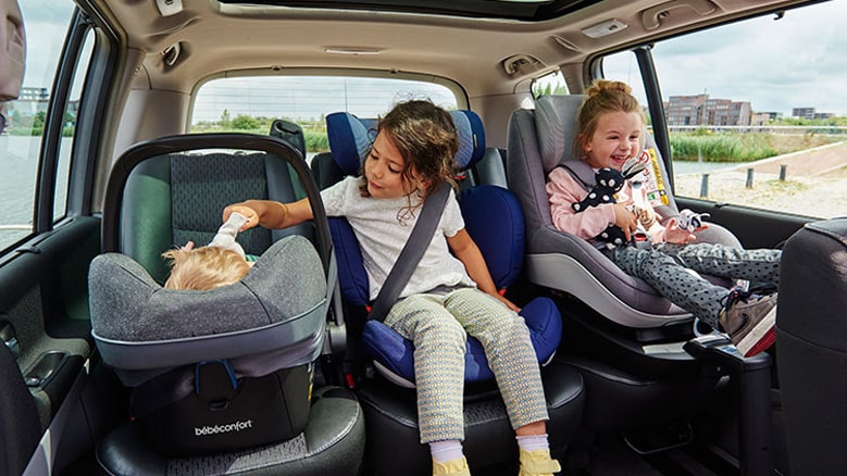 Children safely seated in car seats during a Houston car service with car seats for secure family travel