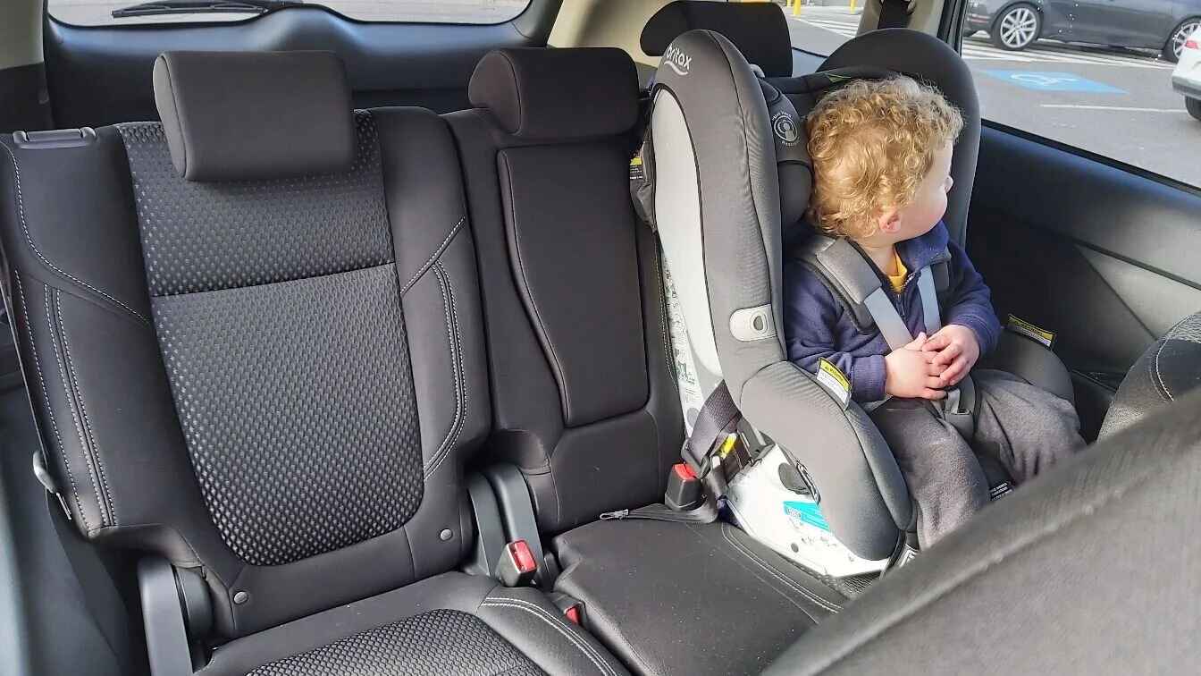 Child safely seated in a car seat inside a clean vehicle offering reliable car service with car seats in Houston