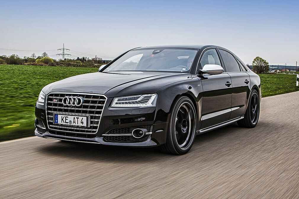 Black luxury sedan driving on highway between Austin and Houston, representing long-distance car service.