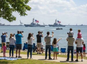 Professional chauffeur opening door of luxury black car for Fleet Week Houston transportation