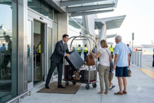 Professional chauffeur providing luggage assistance at Galveston cruise terminal drop-off for Houston cruise passengers